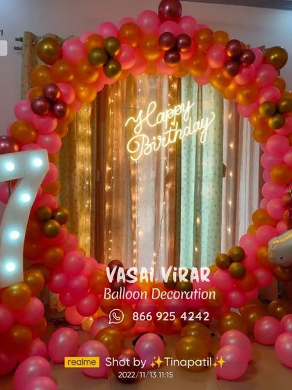 This 7th birthday unicorn party features a vibrant pink and gold balloon ring. The large light-up marquee number and unicorn foil balloons on each side make for a truly magical and celebratory setup.