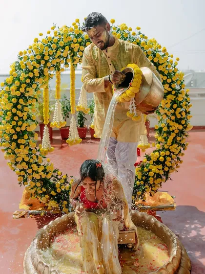 For your Haldi, we create vibrant, joyful settings like this circular marigold arch, perfect for capturing the fun and tradition of the ceremony.
