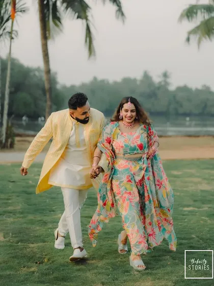 A joyful, candid photograph of a couple walking and laughing together during their pre-wedding festivities. This image embodies my philosophy of capturing authentic moments that feel just like you.