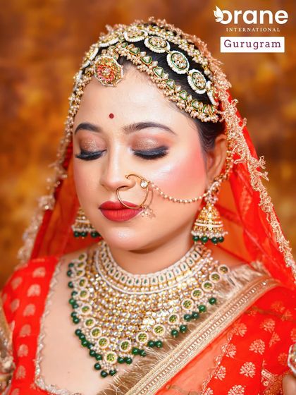 A close up of a traditional Rajasthani bridal look, focusing on the elaborate matha patti and vibrant red attire. My courses delve into regional bridal styles from across India.