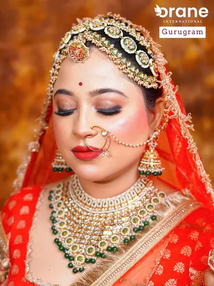 A close up of a traditional Rajasthani bridal look, focusing on the elaborate matha patti and vibrant red attire. My courses delve into regional bridal styles from across India.
