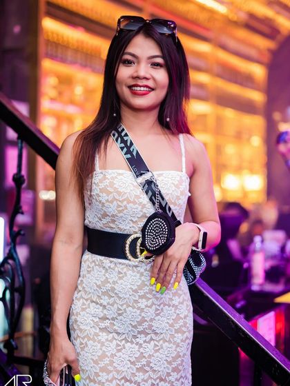 A guest posing in a lace dress.