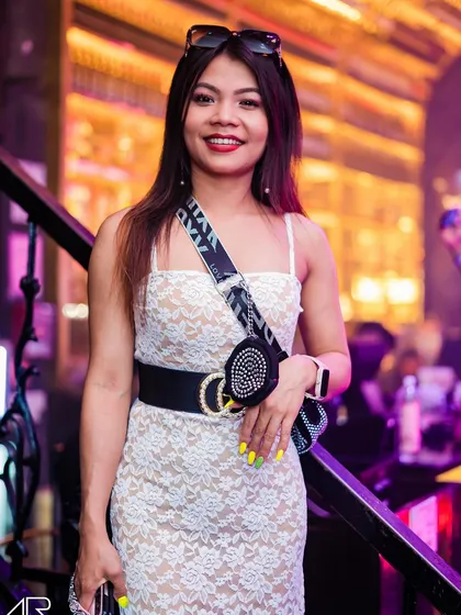A guest posing in a lace dress.