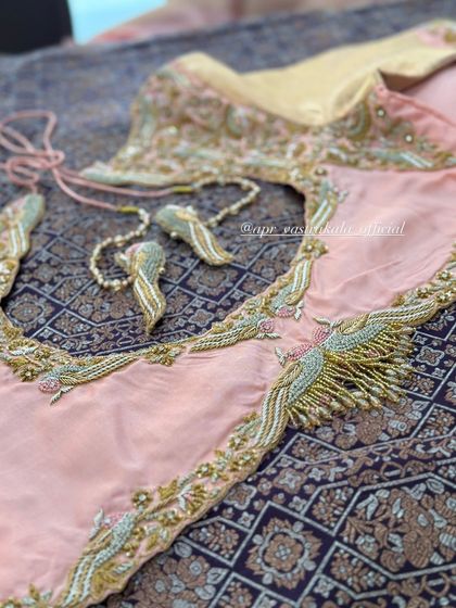 A peach blouse with bird-shaped tassels.