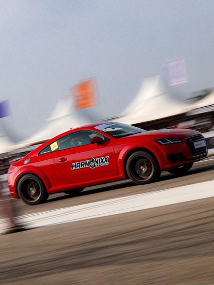 Another view of the red Audi TT, a stylish and capable performance car that's a popular choice for track enthusiasts.
