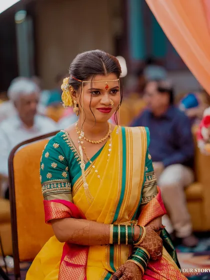 The bride seated during her wedding ceremony, looking serene and beautiful.