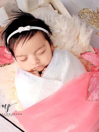 A close-up of the baby's face, showing her delicate features.