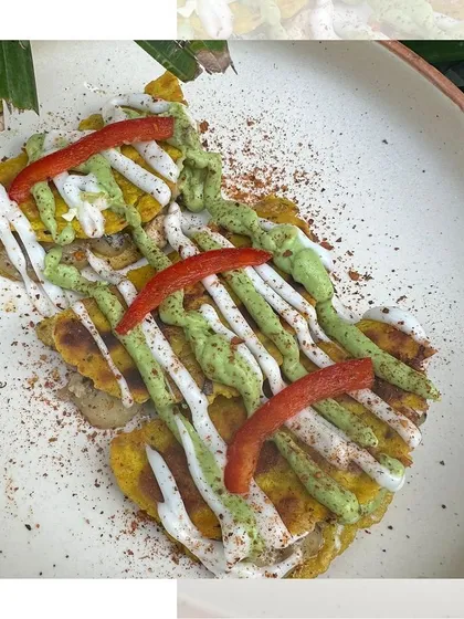A deconstructed taco, artfully plated with colorful drizzles of sauce. This dish showcases our creative approach to food presentation, turning a simple dish into a work of art.
