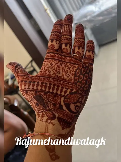 The rich, dark stain of a traditional peacock mehendi design.