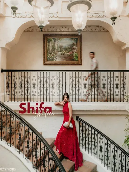 A dynamic portrait of the bride on the grand staircase of Villa Antonia in Austin. The motion blur of the groom in the background adds a narrative element to this beautifully composed shot.