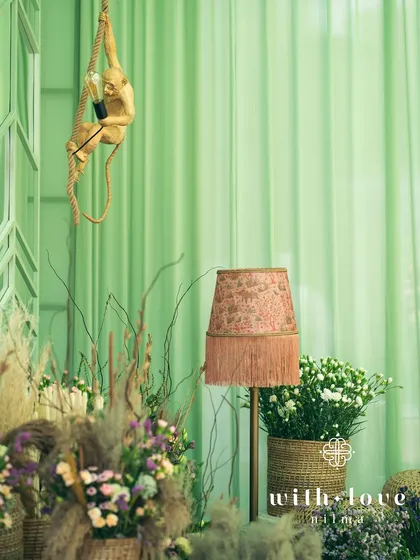 A detail of the decor, featuring a playful monkey lamp hanging from the ceiling.