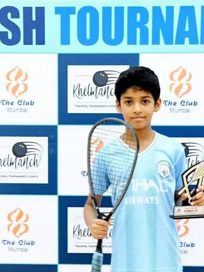 The winner of the U-12 Mix Category at our tournament, proudly holding his trophy. We are dedicated to nurturing young talent.
