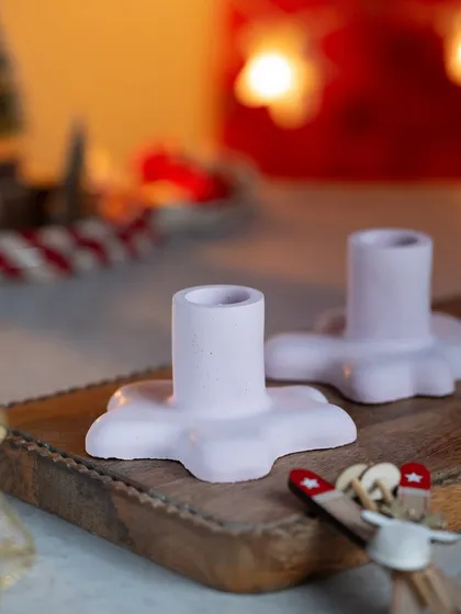 A close-up of the star-shaped candle stands. They are handmade and have a lovely, slightly rustic texture.