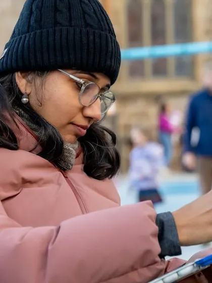 A close-up of me drawing during an outdoor event in a park. You can see the concentration as I use my pen to capture the scene on my clipboard, a typical setup for my live sketching work.