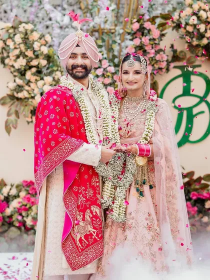 Seeing a bespoke monogram come to life is a magical moment. Here, the 'JB' emblem I designed is beautifully integrated into the floral backdrop of a stunning Amritsar wedding, creating a personal and elegant focal point for the couple's special day.