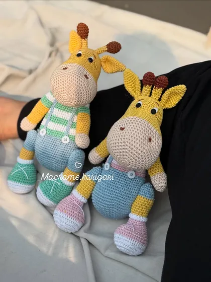 Our two giraffe friends, Tinu and Minu, showing off their different outfits. We love adding small details like stripes and buttons to give each toy its own personality.