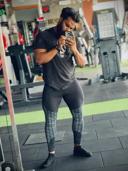 You can't have a strong body without strong legs. A client showing his impressive quadriceps development after a tough leg day.