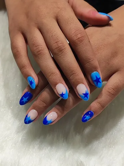 A full view of the trendy blue star-themed manicure.