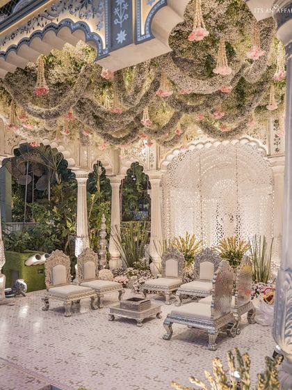 A view of the mandap showcasing the stunning floral ceiling installation. Cascading baby's breath and roses create a cloud-like effect, adding a layer of texture and romance to the ceremony space.