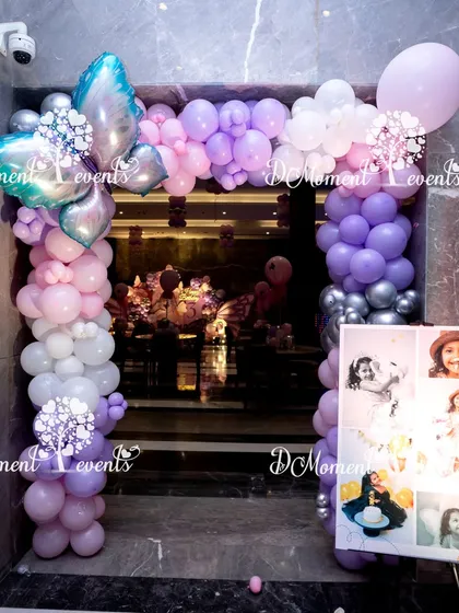 The entrance to Nyra's party, featuring a beautiful balloon arch with a large silver butterfly foil balloon, perfectly setting the theme from the moment guests arrive.