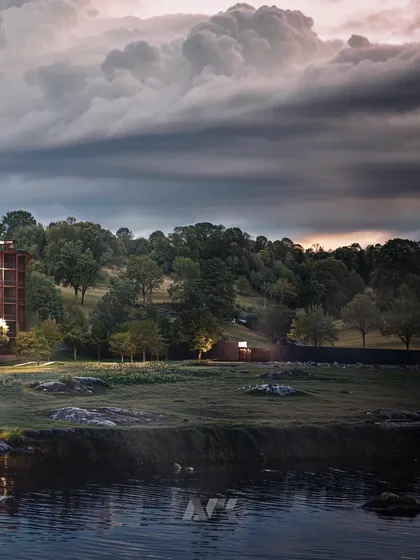 A dramatic, moody render of the Westin Nashik at dusk. The lighting design highlights the architecture's connection to the water and the surrounding natural environment.
