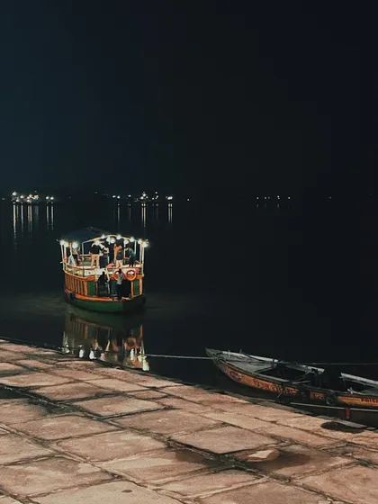 a boat docked at the ghats at night. the reflection on the water and the quiet stillness of the scene influence my approach to creating calm, focused user experiences.