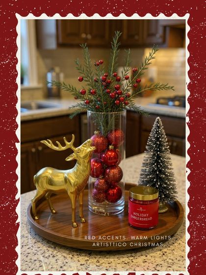 Red accents and warm lights define the Artisttico Christmas. A golden reindeer, a gingerbread candle, and a vase of berries create a simple yet beautiful holiday display.