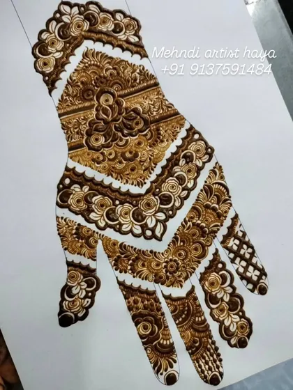 This is a practice sheet of a full-coverage bridal design. We work on paper like this to perfect the layout, flow, and combination of different fillers like floral bands and cross-hatching before applying to skin.