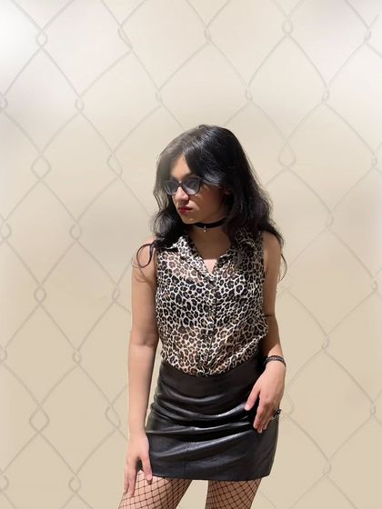 Some pre-show shenanigans, rocking a leopard print and leather skirt. This photo captures my rockstar aesthetic and the fun of getting ready for a gig.