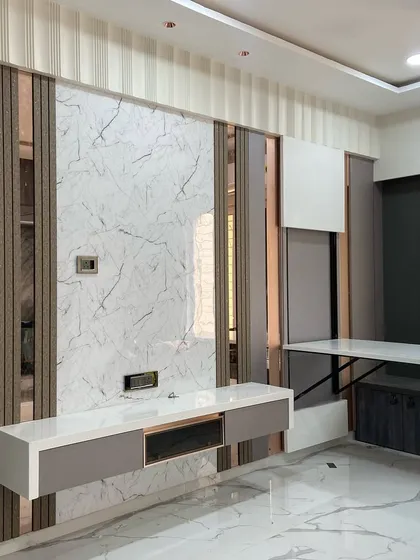 To maximize floor space in this Kandivali apartment, I designed a folding dining table that seamlessly integrates into the wall paneling and TV unit. When not in use, it folds away completely, demonstrating my approach to smart, space-saving furniture.