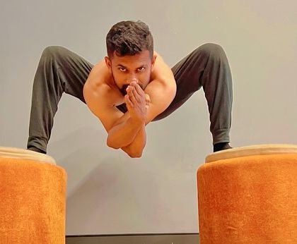 A floating frog pose variation, which requires immense core and upper body strength. This is a testament to what consistent practice can achieve.