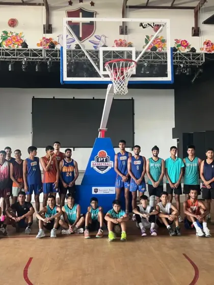 A team photo before a practice match at an indoor facility. We ensure our players get experience on different types of courts.