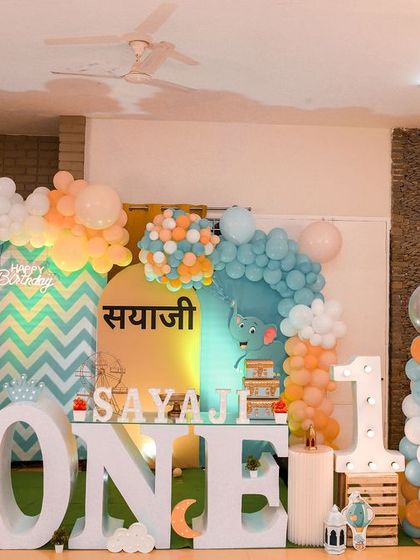 A magical 'Mermaid' themed birthday party, with shimmering blue and green decor, seashell props, and mermaid cutouts, creating an enchanting underwater world.