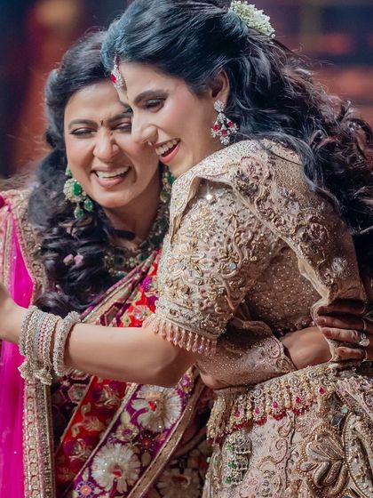 A beautiful, candid moment of a mother and daughter embracing on stage after their performance. These are the precious, unscripted moments we cherish.