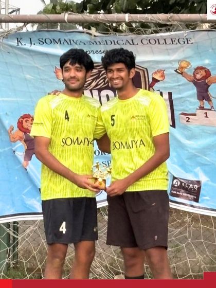 Two players from the winning football team receiving their trophy. We ensure that individual contributions are celebrated alongside team success.