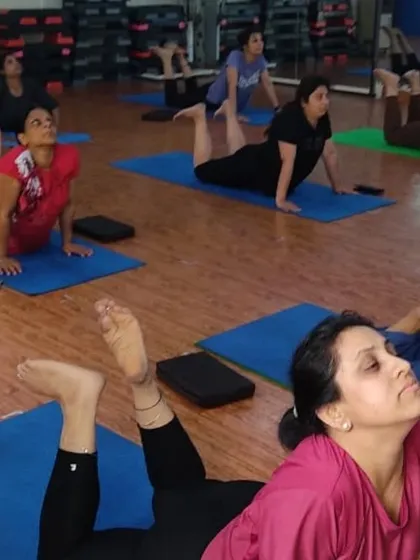 A close-up of students in Bhujangasana (Cobra Pose). This pose is excellent for spinal health and opening the chest, and I always guide students to practice it with awareness to protect the lower back.