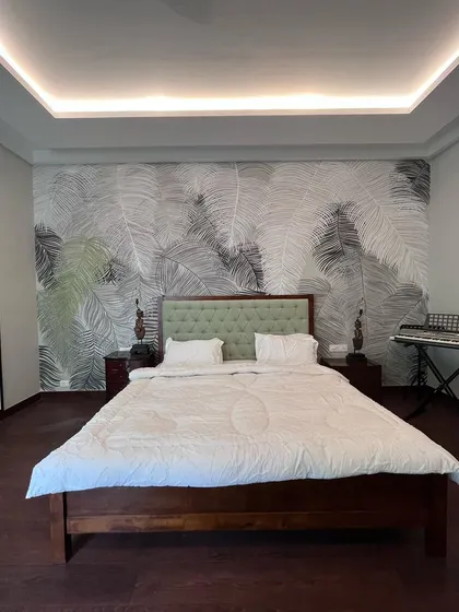 Subtlety and finesse define this grayscale tropical mural. The delicate, almost transparent leaves create a soft, dreamy atmosphere in this luxury villa bedroom.