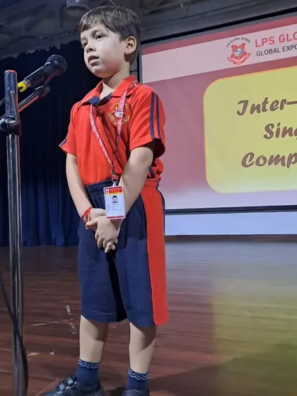 A young boy delivers his song with earnest expression during the Inter-House Singing Competition.