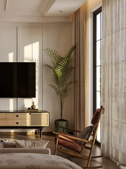 The TV console, also with cane detailing, sits opposite the bed. The design maintains a cohesive, classic aesthetic throughout the room.