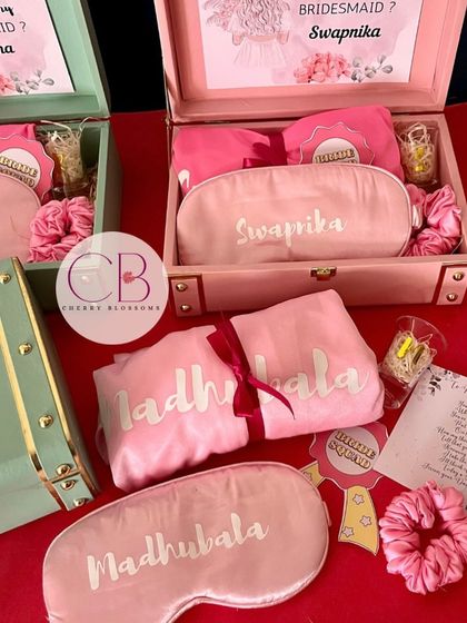 A close-up of our personalised bridesmaid proposal boxes. Each trunk box is customised with a name and filled with goodies like a robe, eye mask, and a card asking, "I can't say I Do without you."