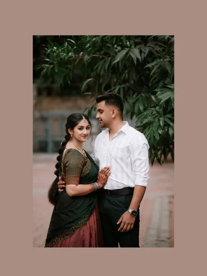 A simple, elegant portrait of the couple against a natural backdrop. Their comfortable pose and gentle smiles reflect their easy love for one another.