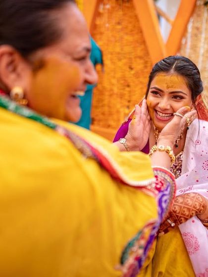 A tender moment between the bride and her mother during the Haldi ceremony. I focus on capturing these priceless family interactions.