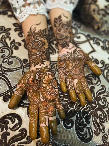 A complete set of intricate henna for both hands, ready for a special occasion. You can see how the patterns on each hand complement each other to create a full, beautiful look.