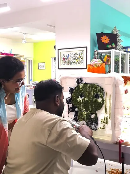 I love seeing the teamwork during a couple's session. Here, I'm helping guide the tufting gun, but the creative vision for this cute green character is all theirs.