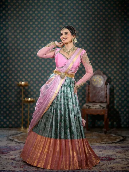 A full-length shot of a modern half-saree look, perfect for an engagement or pre-wedding function.