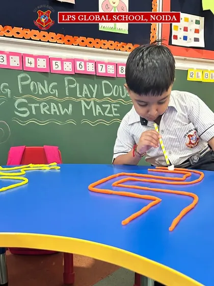 A young student navigates a zigzag maze, showcasing his developing coordination. Our classrooms are filled with activities that make learning feel like play.
