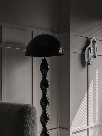 Another view of the lighting details at Frenchie Haus. The play of light and shadow against the wall paneling adds depth and drama to the room.