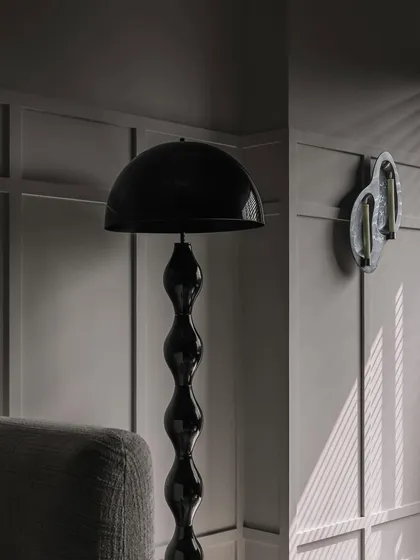 Another view of the lighting details at Frenchie Haus. The play of light and shadow against the wall paneling adds depth and drama to the room.