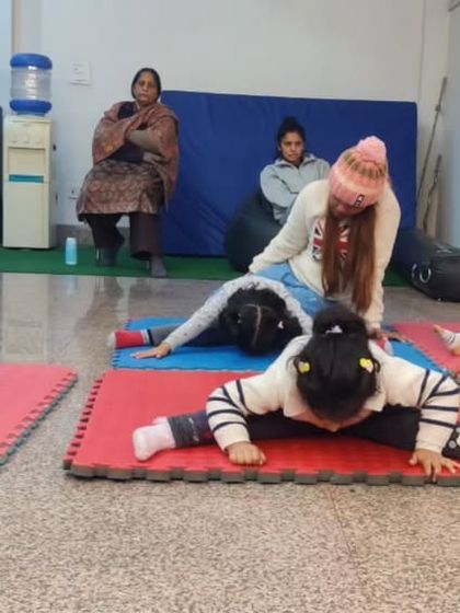 Even our youngest students learn the importance of stretching. Here's a look at our toddlers working on their flexibility, with proud parents watching on.