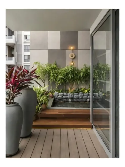 A balcony at Peninsula Heights transformed into a private retreat. A custom water feature with river stones, bamboo, and accent lighting creates a zen-like atmosphere, proving that even small spaces can become luxurious sanctuaries.
